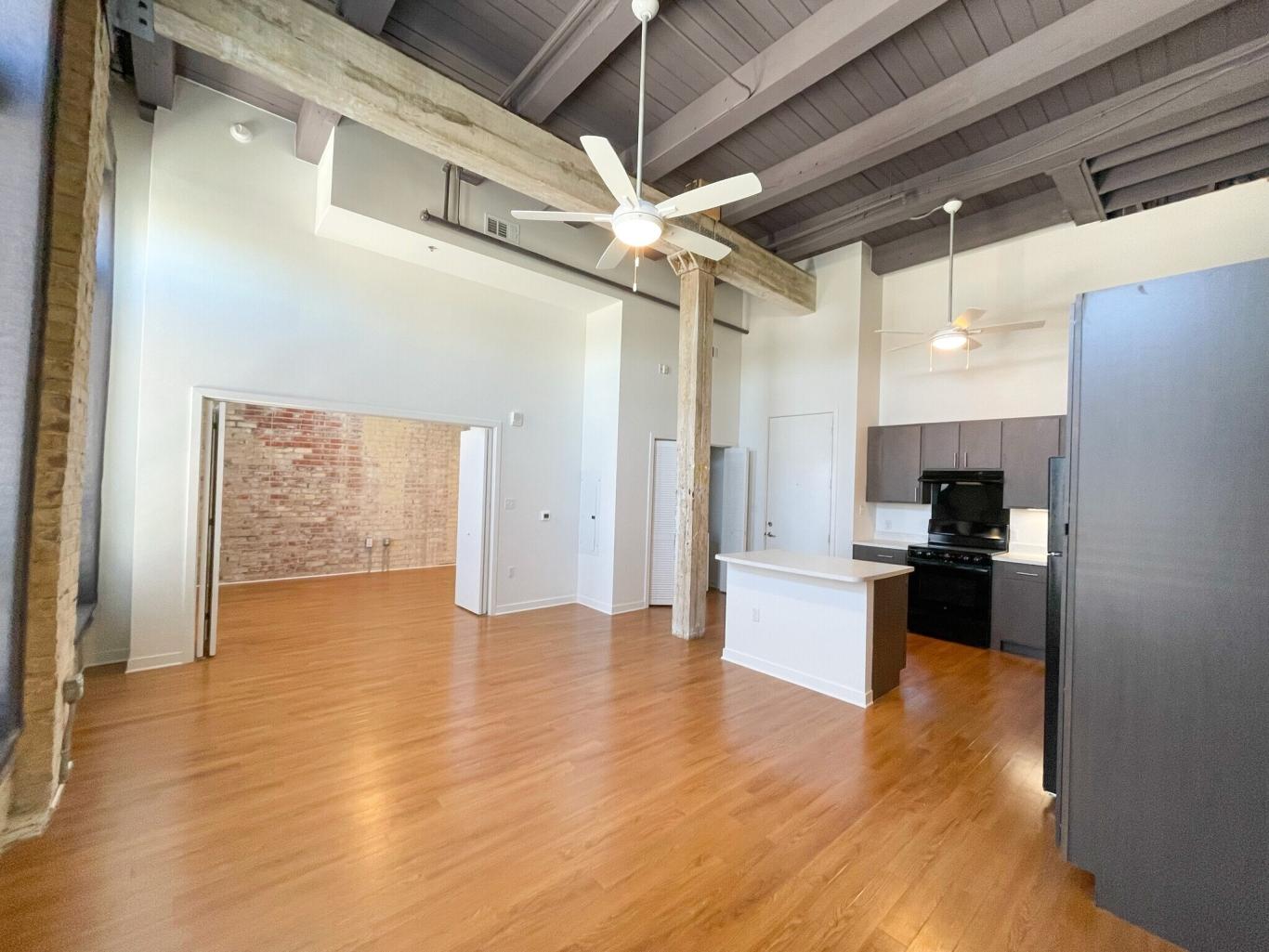 A charming loft space with exposed beams and wood floors.