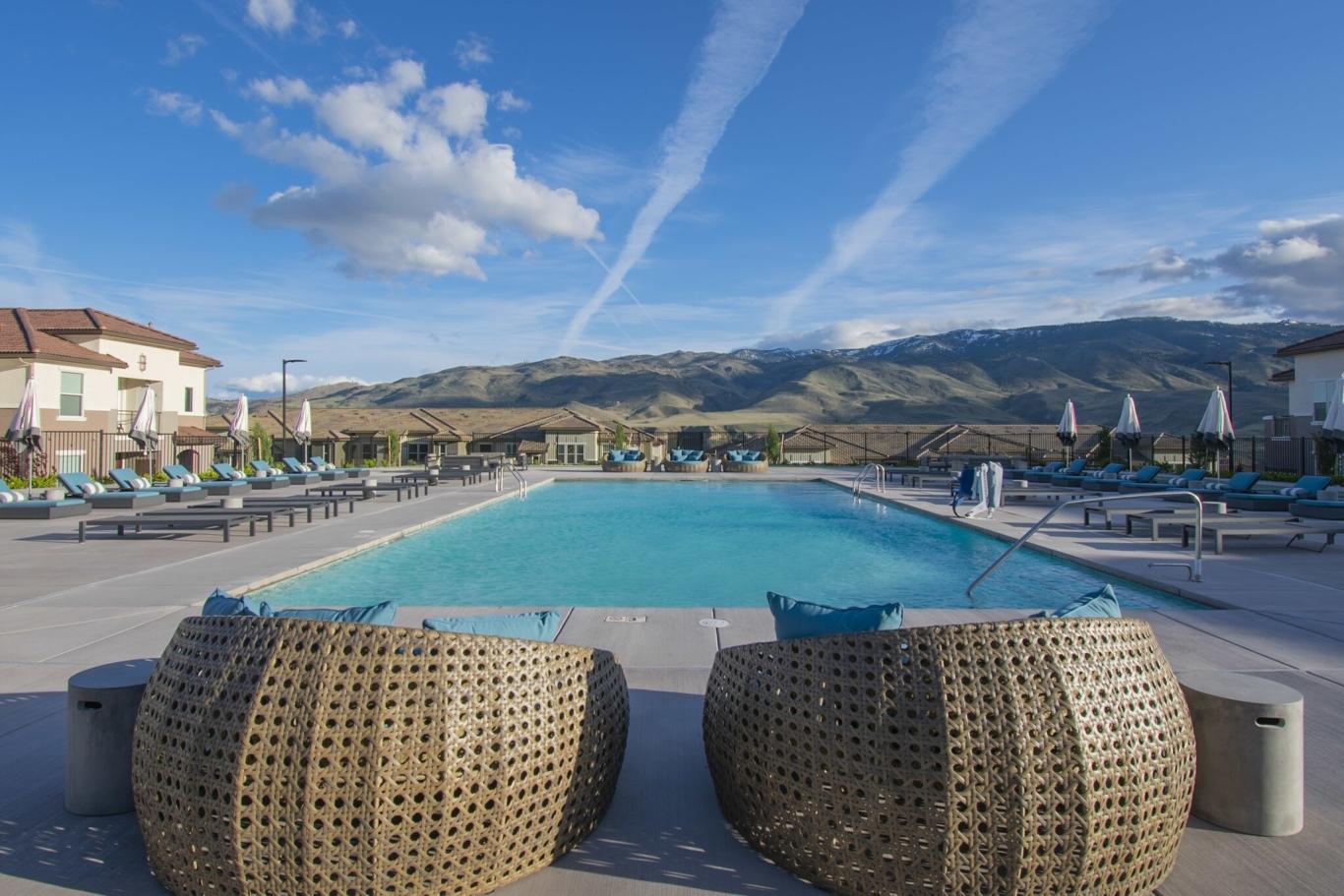 Outdoor swimming pool with mountain view.