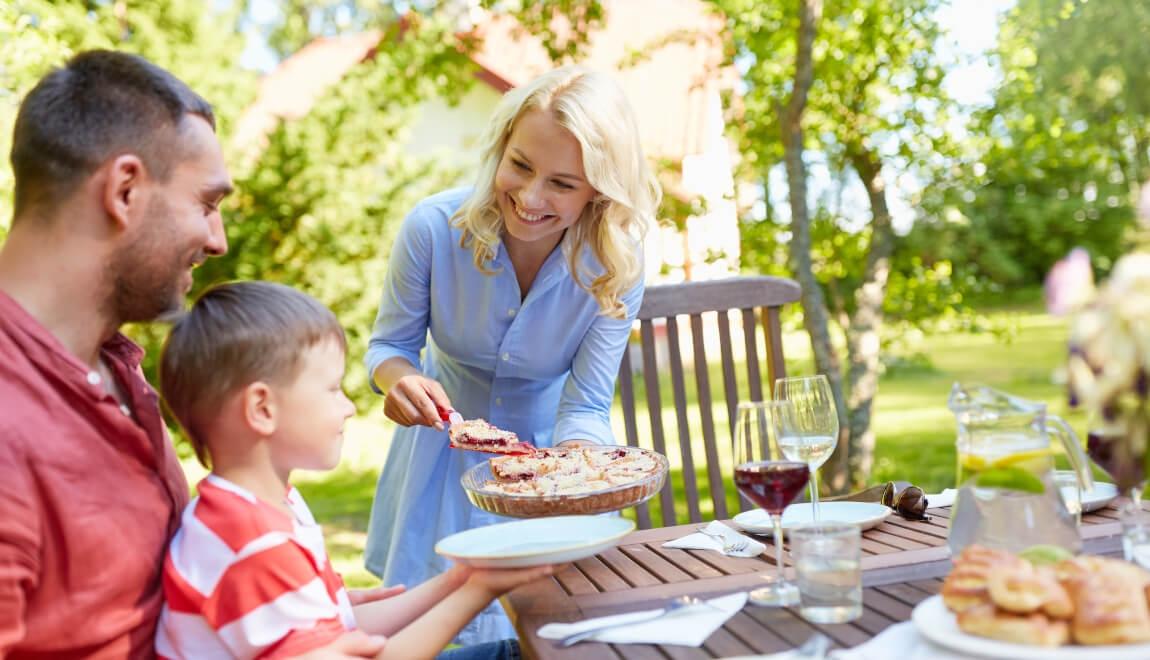 An image of a parent serving their child food.