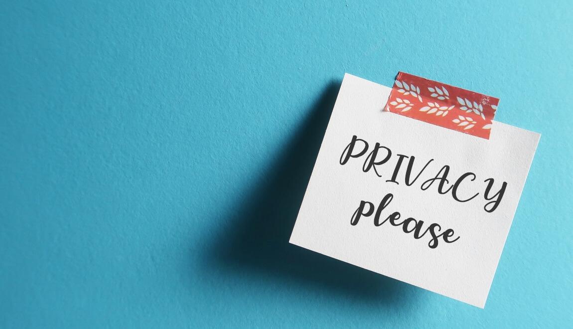 An image of a sticky note that has "privacy please" written on it. 