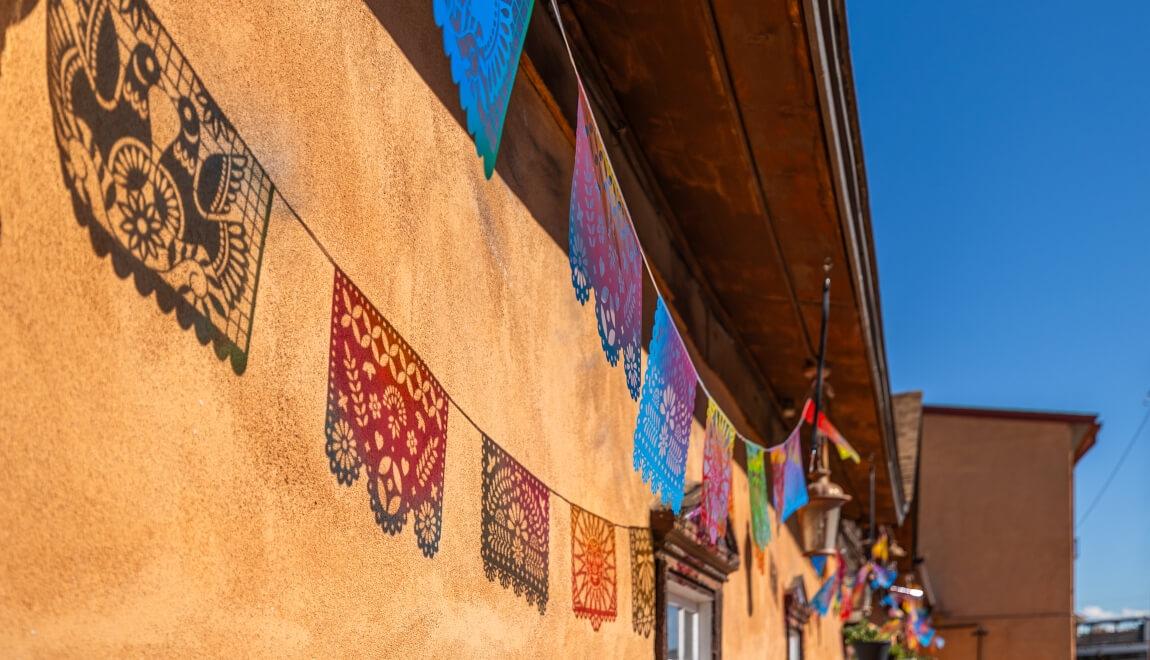 Adobe building decorated with colorful garlands