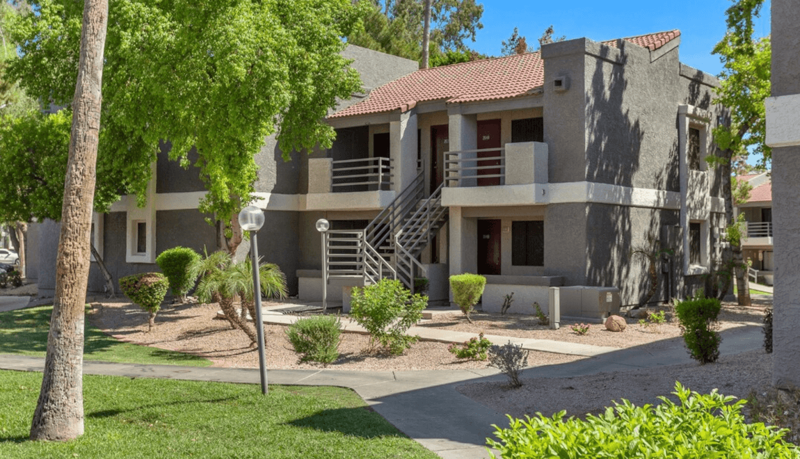 A stucco building at North Mountain Village Apartments