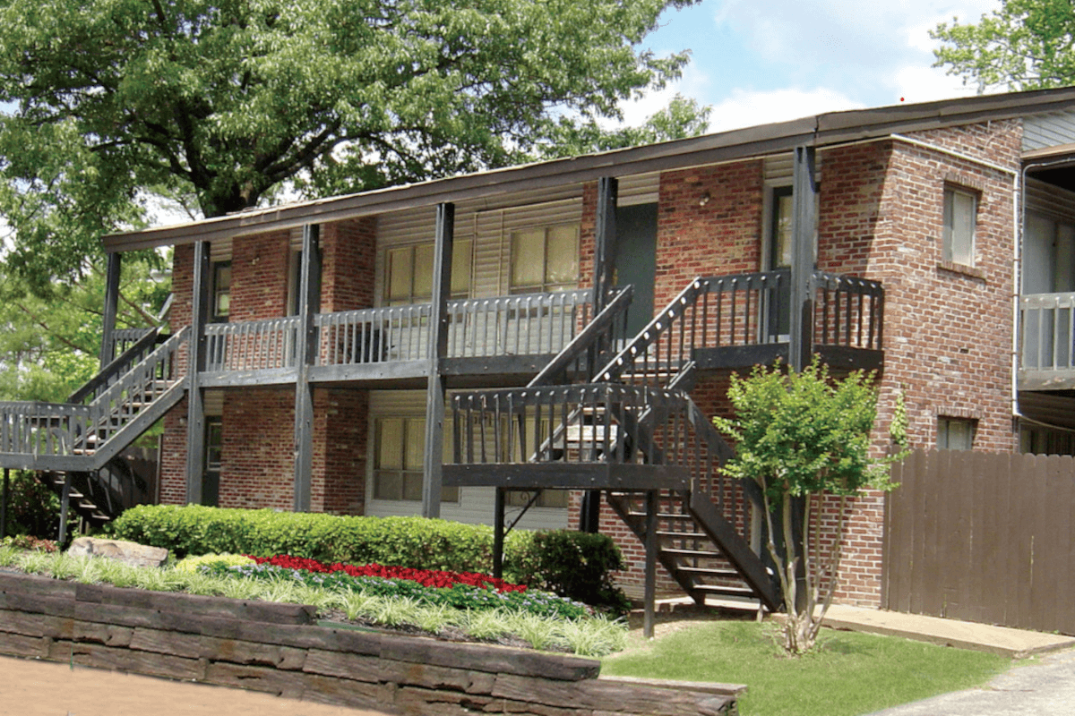 Scenic Hills Apartments in Raleigh, Memphis, are landscaped with flowers, hedges, and trees.