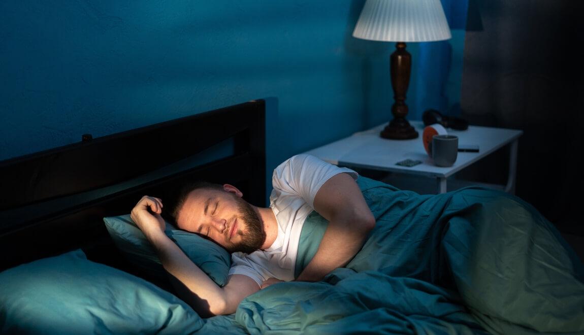 Renter relaxing in his apartment bedroom.