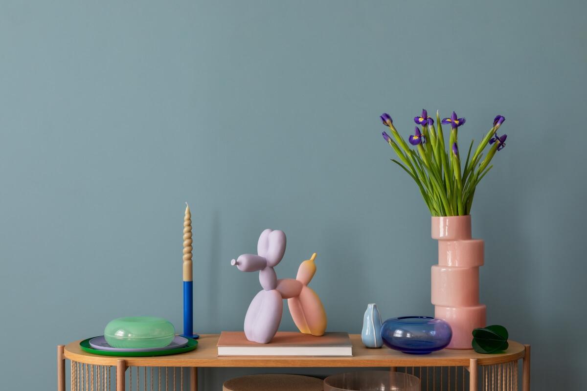 Colorful trinkets sit on a decorative side table.