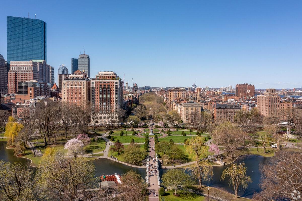 An aerial view of Boston Common with the city skyline in the background.