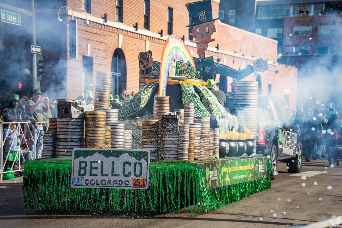 A festive St. Patrick’s Day float cruises through Downtown Denver.