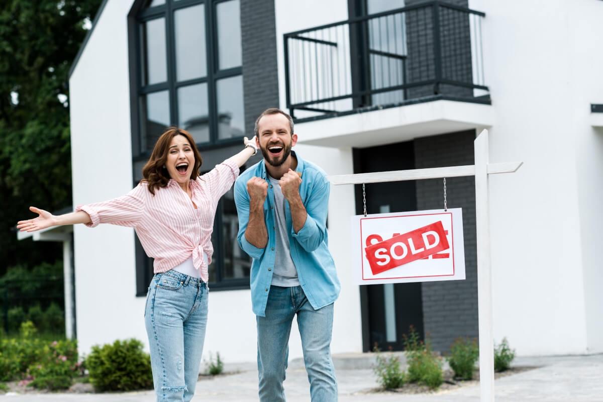 A couple celebrates buying a home.