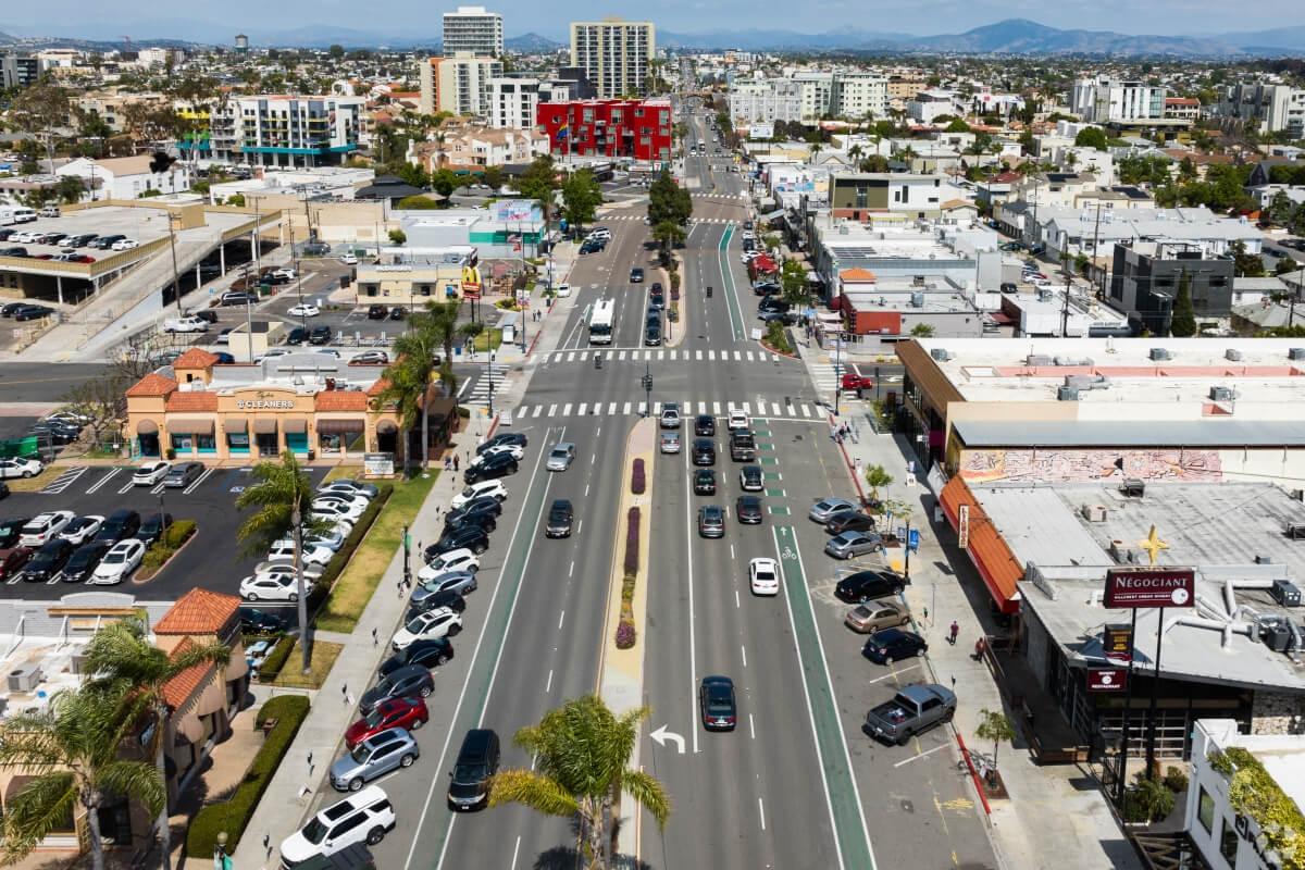 Aerial view of a street-lined area with businesses in Hillcrest