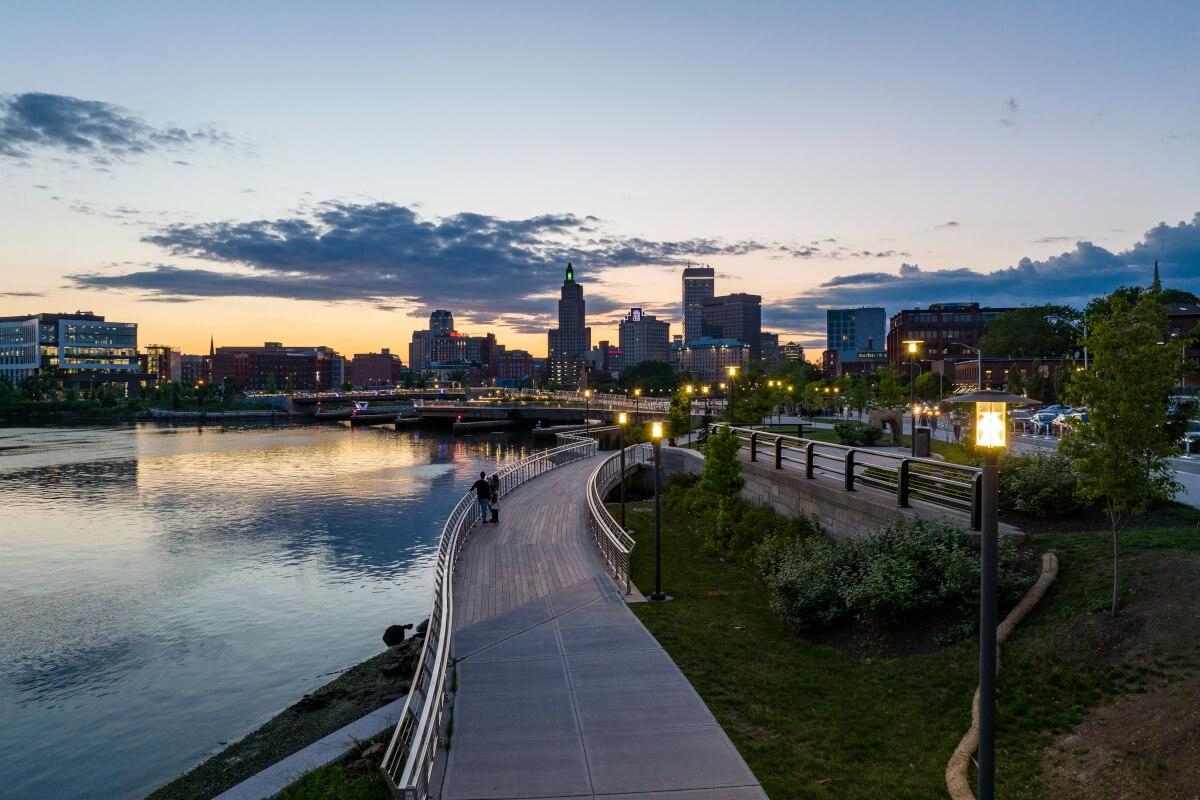 A distant shot of the Downtown Providence skyline at night is shown from the Fox Point neighborhood.