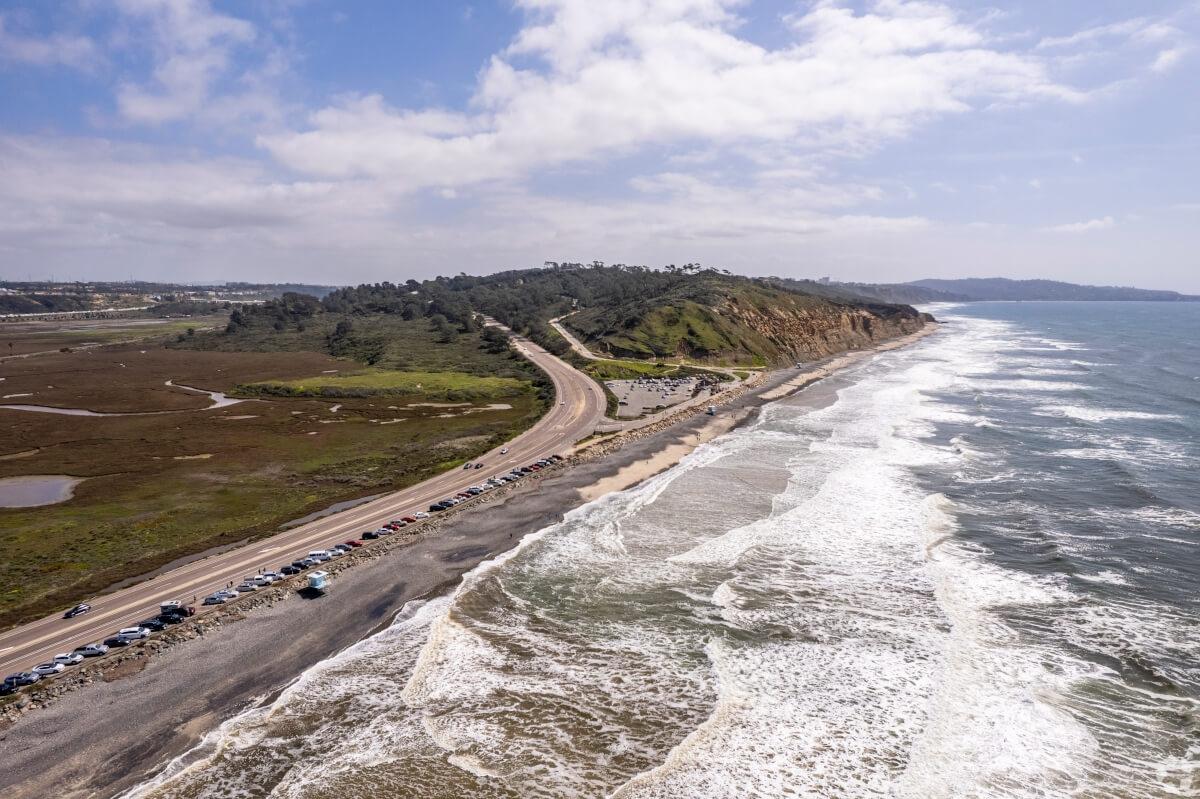 Aerial shot of the beach and the road leading to Torrey Pines State Natural Reserves.