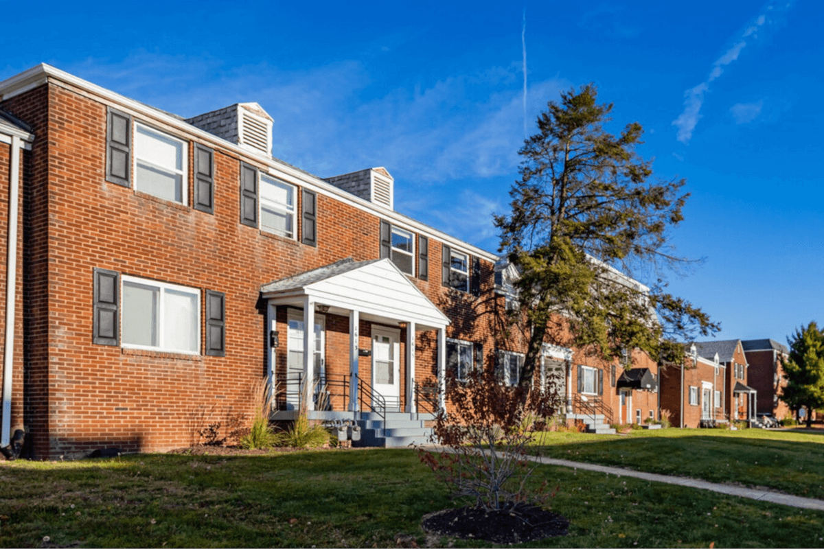 The Hillside Meadows apartment community is made up of a series of red brick colonial buildings.