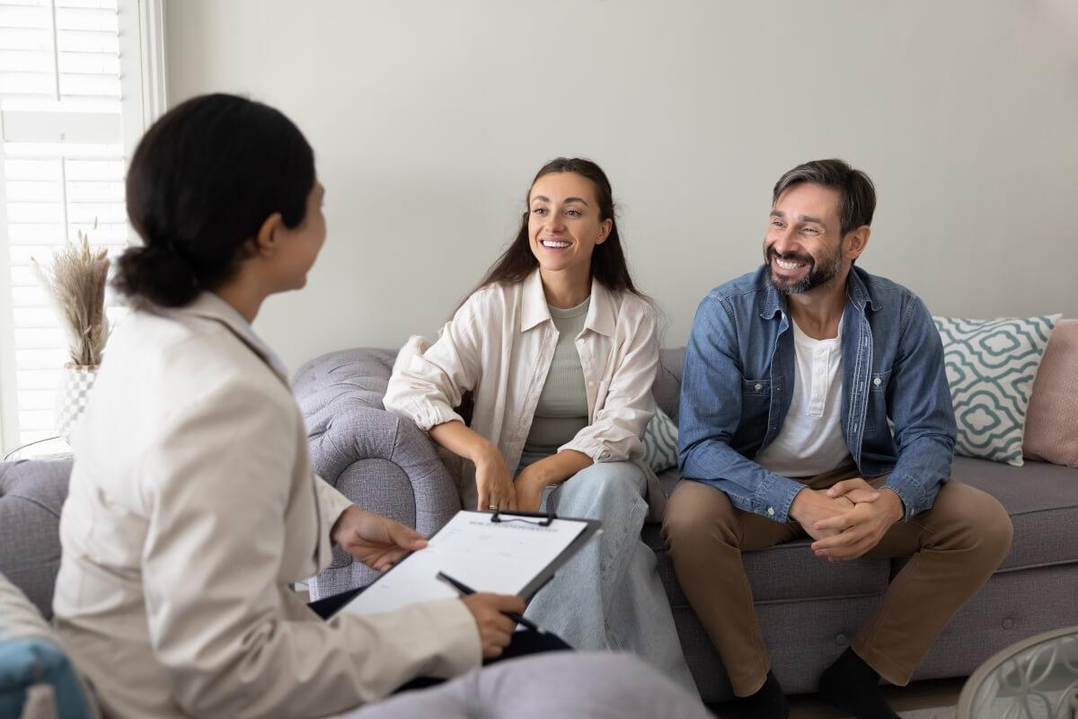 A private landlord talks with a young couple.