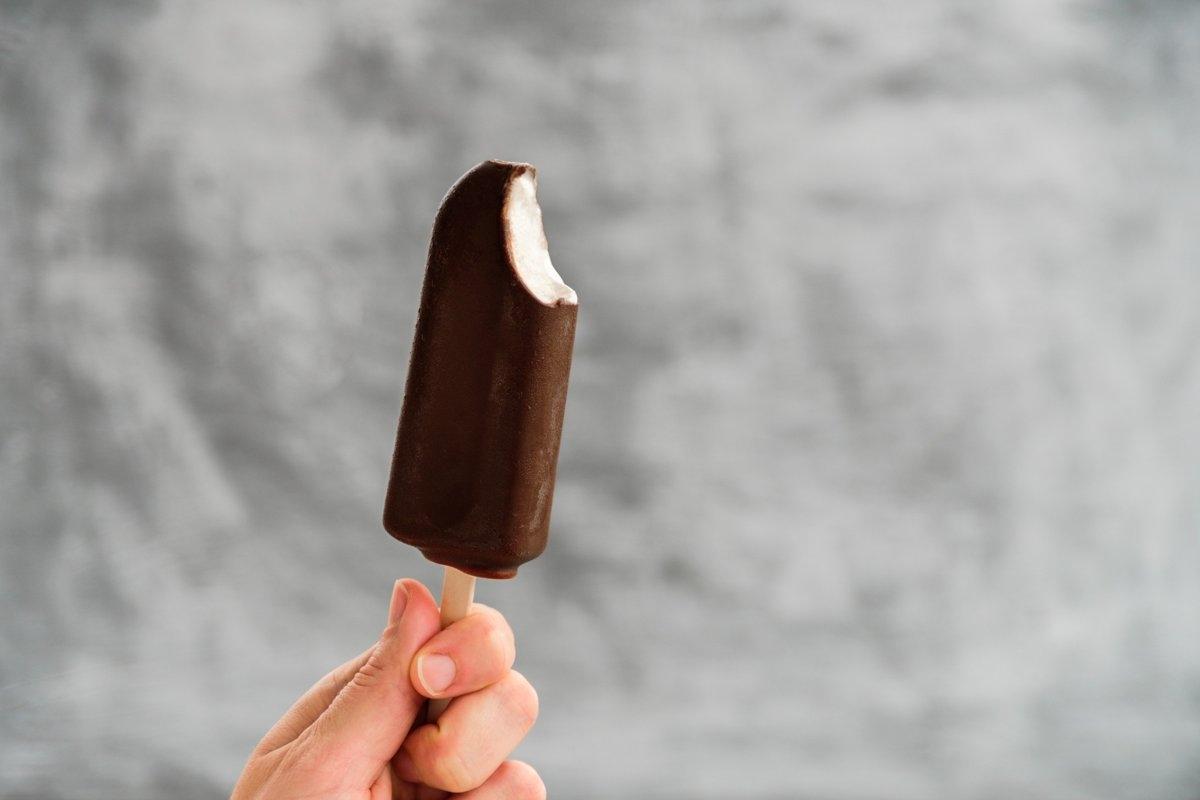 Chocolate-coated ice cream bar on a stick