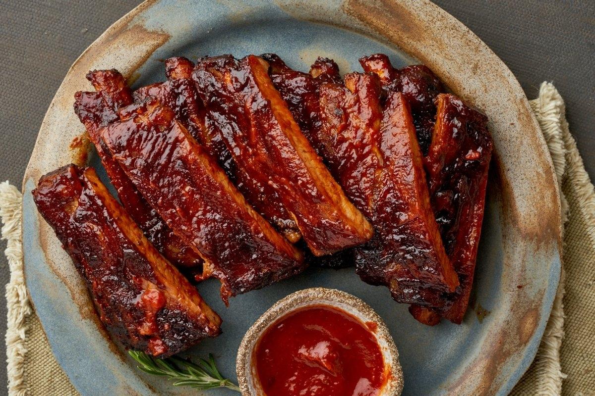 A plate of barbecue ribs with sauce