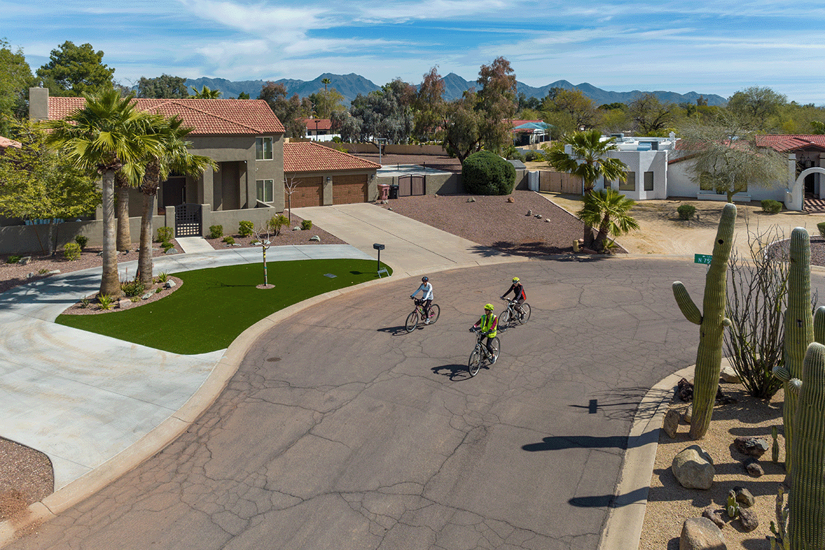 Three residents bike through a neighborhood in Scottsdale.