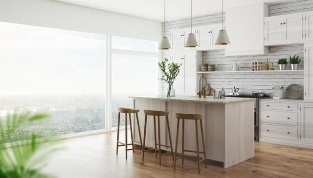 Modern apartment kitchen with white cabinets and an island.