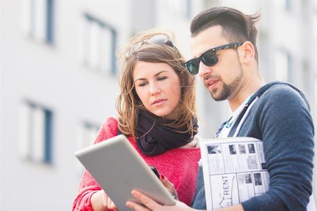 Couple looking at apartment on a tablet.