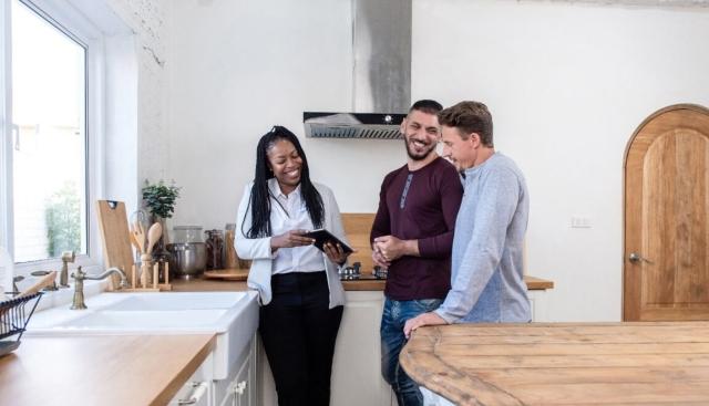 Couple touring apartment with an agent.