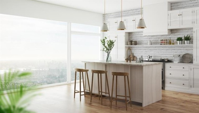 Modern apartment kitchen with white cabinets and an island.