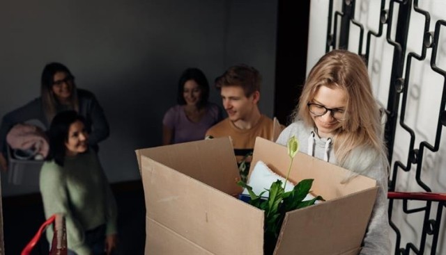 A young woman moving out of college