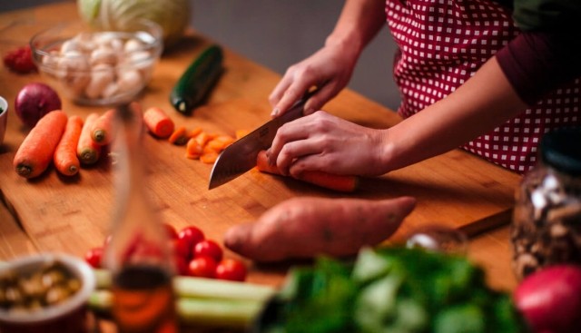 Person slicing carrots during dinner prep