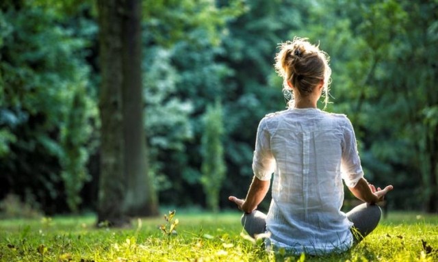 Woman meditating outside