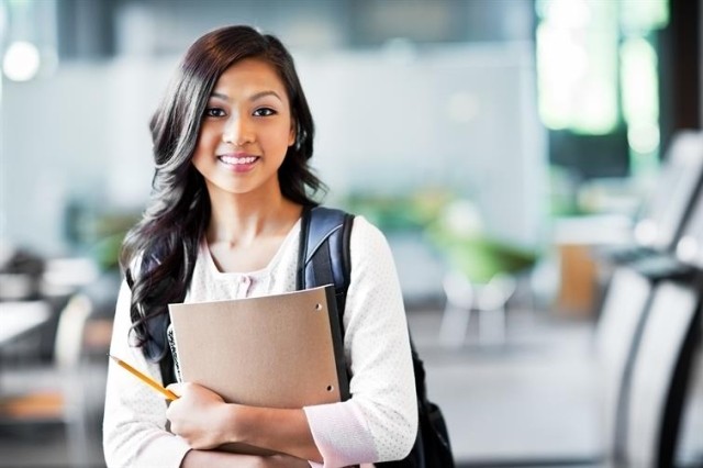 A college student smiling at the camera