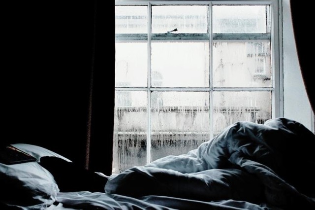 Raindrops on a window in a bedroom