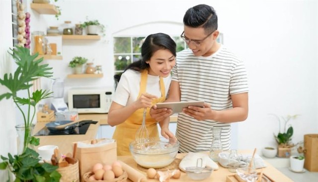 A couple looking at a recipe in the kitchen