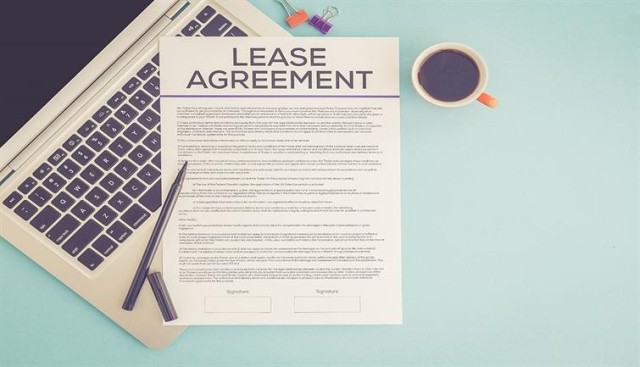 lease agreement on laptop with coffee