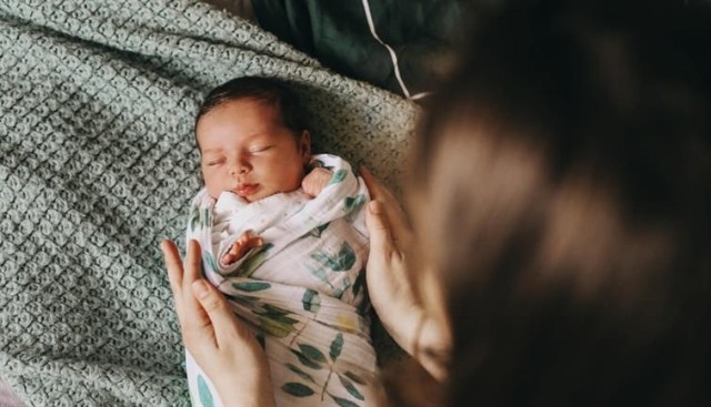 A swaddled newborn