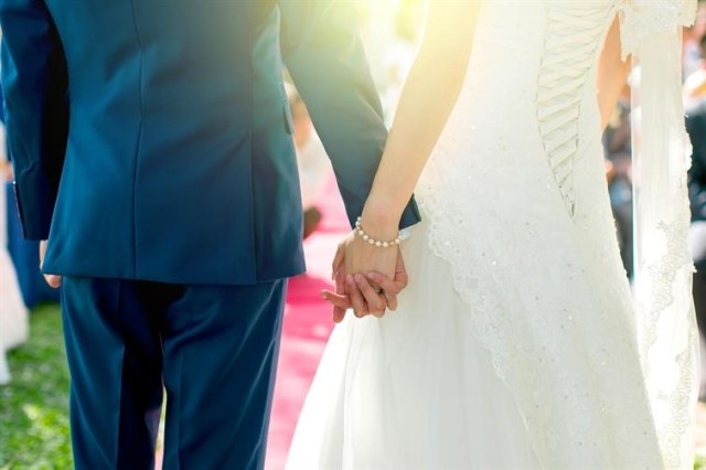 Bride and groom holding hands