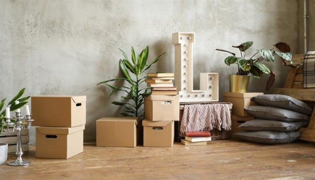 A moving pile of boxes, pillows, and decorations