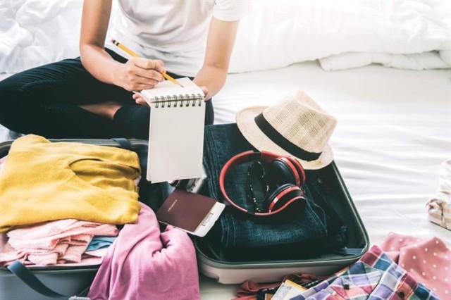 A person packing a suitcase