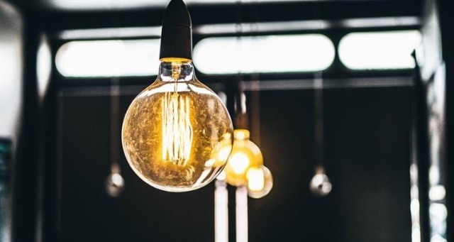 Close-up of a lightbulb with a soft golden glow.