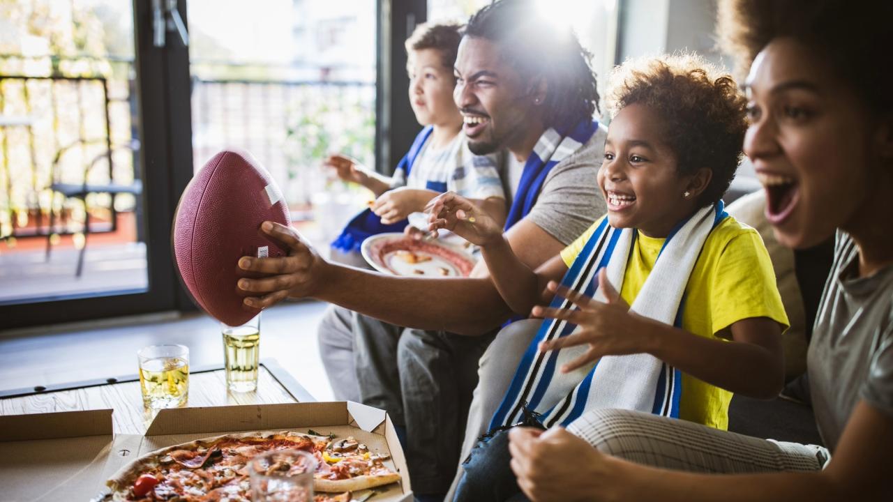 Sports watch party with pizza and football