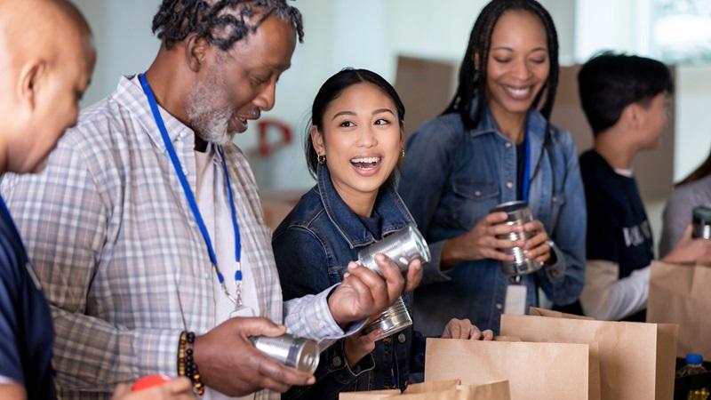 Food bank volunteers smile and chat