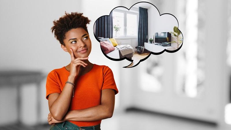 Woman stands in room imagining new apartment