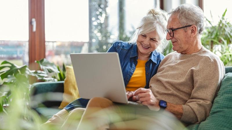 Senior couple looks at laptop together