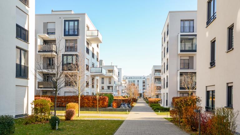 A walkway between two rows of apartments