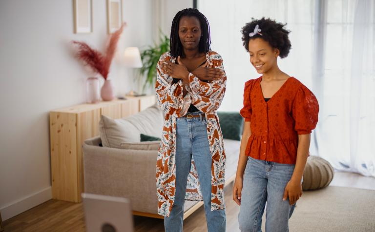 Two women looking at a phone to record a TikTok