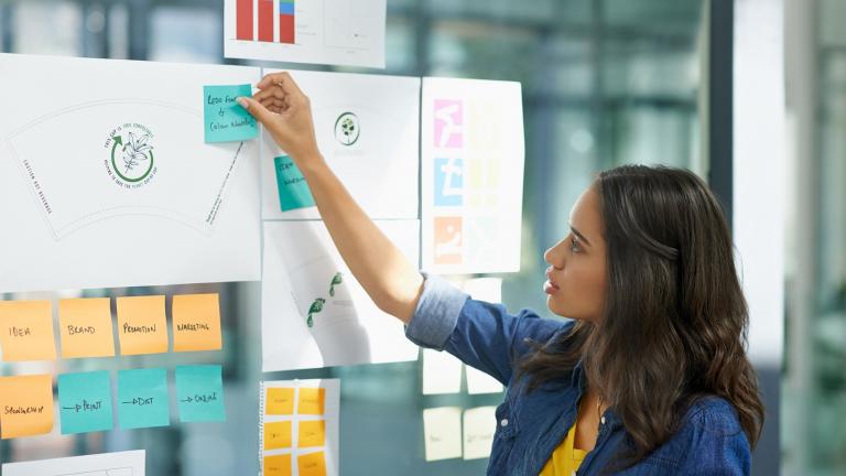 Woman plans content with sticky notes