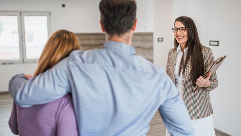 Leasing agent offers a couple a tour of an available apartment