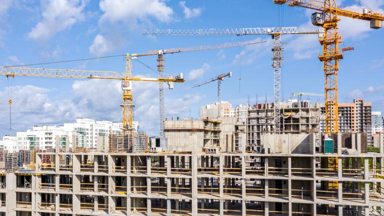 Construction in progress with cranes overhead