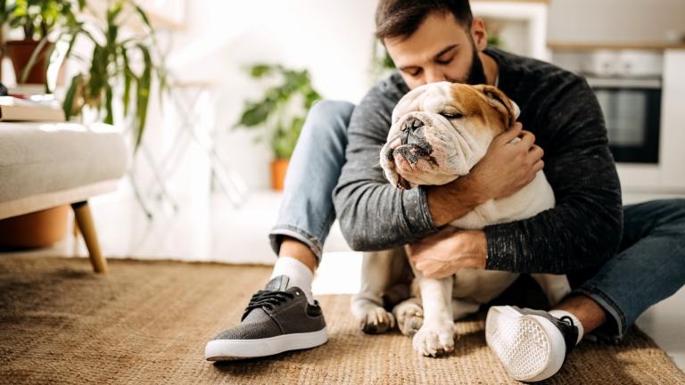 Renter hugs his pet dog