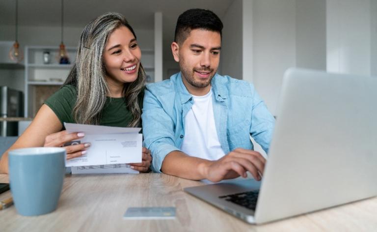 Couple searches for apartment on computer