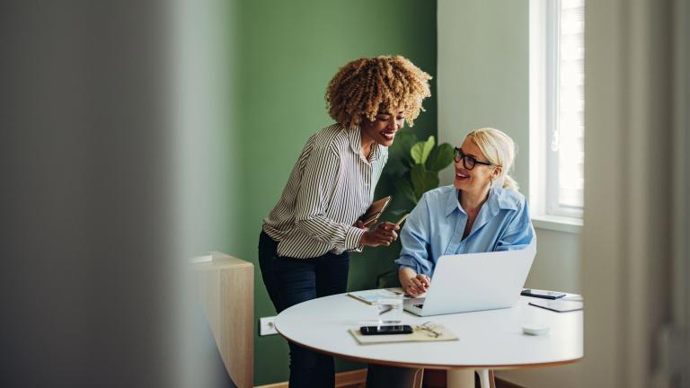 Women talking in green office