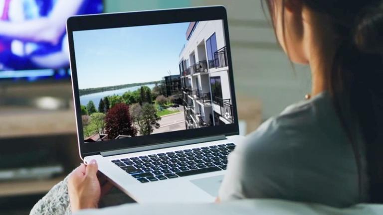 Renter looks at property via laptop screen