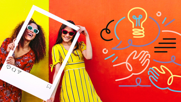 Two smiling women hold Instagram picture frame